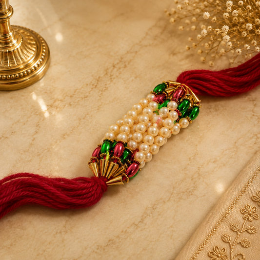 Premium Beaded Pearl Rakhi – Red Mauli Thread with Green & Red Decorative Beads