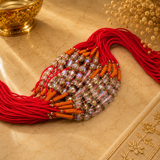 Beaded Rakhi – Red Mauli Thread with Orange Beads & Designer Work