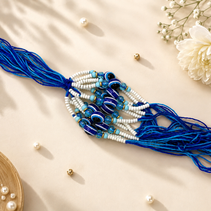 Evil Eye Lumba Rakhi – Blue & White Pearl Beads with Designer Tassel