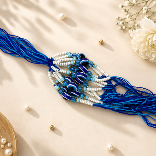 Evil Eye Lumba Rakhi – Blue & White Pearl Beads with Designer Tassel